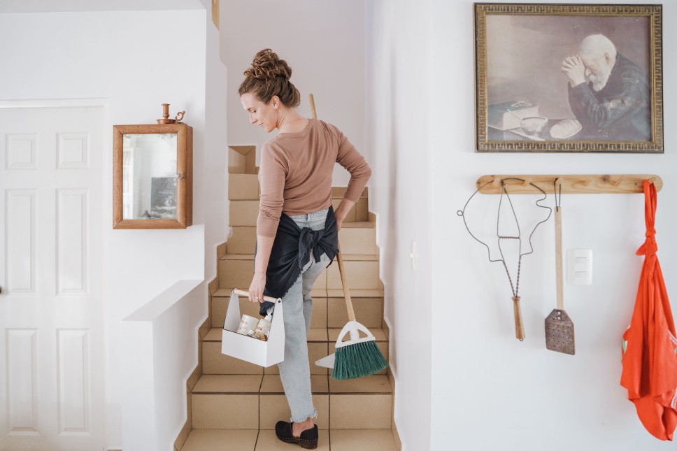 Image of a woman cleaning her home
